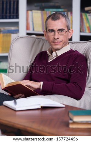 Handsome successful lawyer reading a book