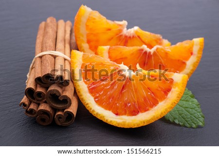 Fresh oranges with cinnamon sticks
