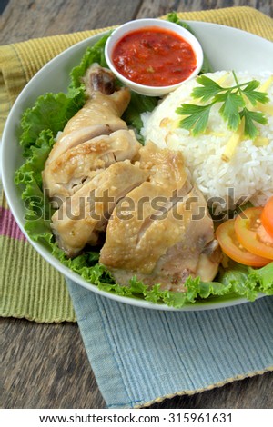 Steamed chicken rice with rice, tomato and chili. Famous food in South East Asia