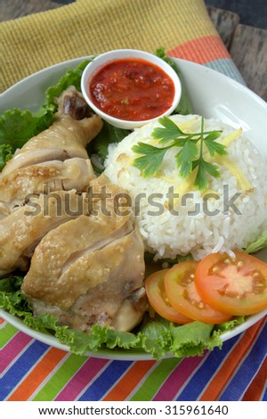 Steamed chicken rice with rice, tomato and chili. Famous food in South East Asia