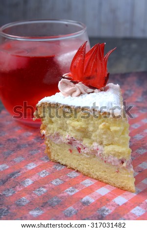 Sponge Cake with roselle or rosella jam in the middle and roselle fruit on top of rosella cream flavour. served with refreshing roselle juice.