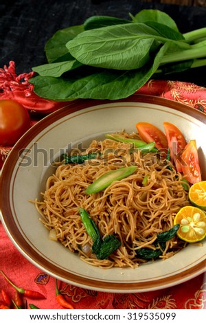Fried bee hoon with vegetables. Famous Chinese Food in South East Asia. Rice vermicelli stir fried with vegetables, tomato and lime.