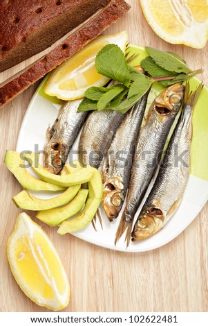 Smoked sprat fish with bread above view