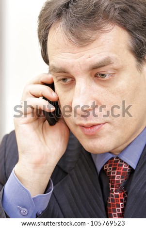 Middle aged businessman on phone closeup photo