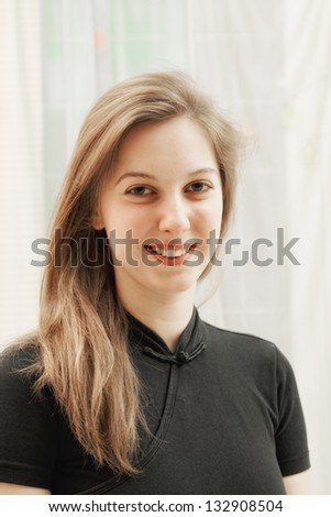 Portrait of young caucasian woman in black shirt