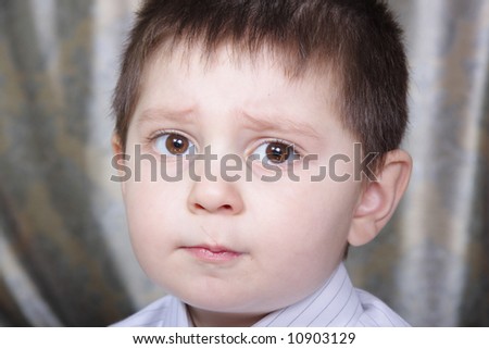 Little boy with question in eyes expression