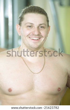 Funny young bodybuilder smiling waist up photo