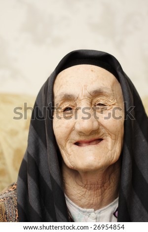 Happy granny smiling head and shoulders portrait