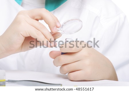 Researcher hands with magnifying glass closeup photo