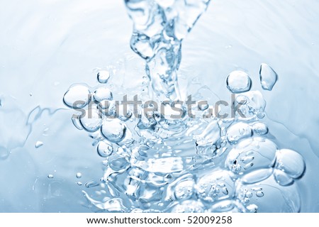 Water leaking to puddle making bubbles closeup photo