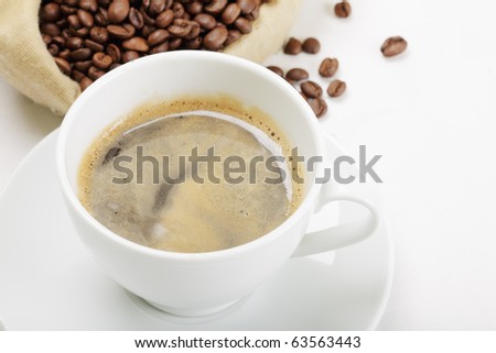 Espresso in white cup and coffee bag on light tabletop