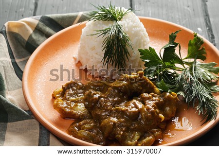 Lamb curry  served with white steamed rice closeup