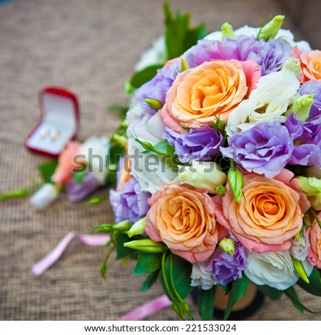 bridal bouquet of roses and wedding accessories, shallow depth of field