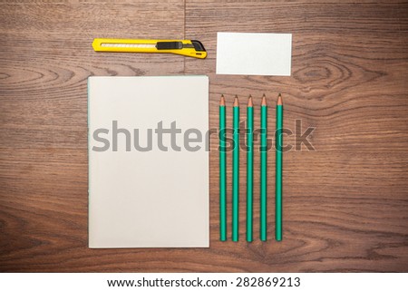 Business card book, notebook and pencil on a wooden background.Mock-up for branding identity.