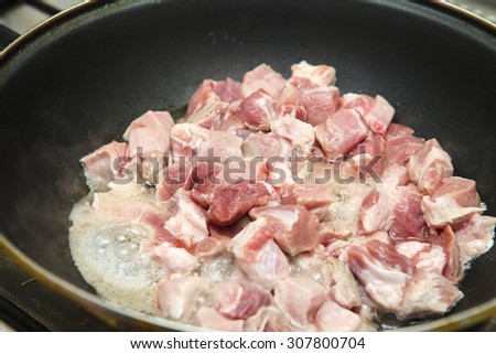 meat cut into pieces fried in a pan