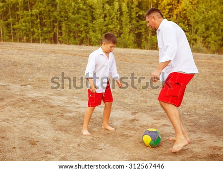 Dad and son playing ball outdoors