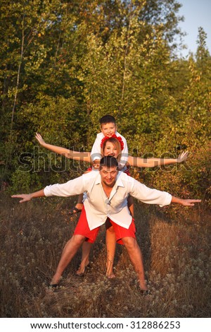 mom dad and son fooling around outdoors