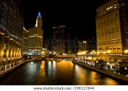 The buildings and architecture of Downtown Chicago at night, by the Chicago River between The Loop and the Magnificent Mile areas.