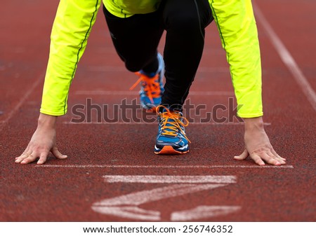 A professional runner preparing for the start on the start line
