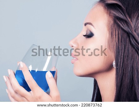 beautiful young woman with a glass of alcoholic drink