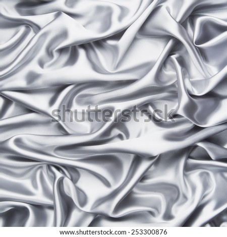 abstract background luxury cloth or liquid wave or wavy folds of grunge silver silk texture satin velvet material or luxurious