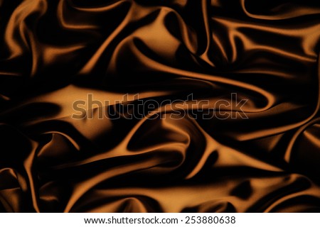 abstract background luxury cloth or liquid wave or wavy folds of grunge copper silk texture satin velvet material or luxurious