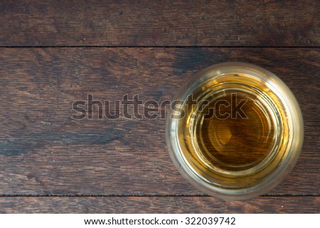 Whiskey Bourbon in a Glass on wooden background