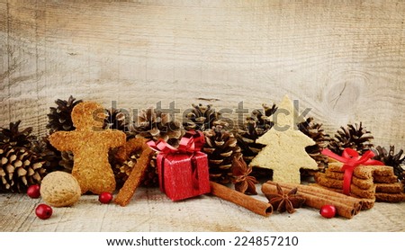 Christmas various gingerbread cookies with red gift, christmas tree, santa claus, stick scene on wooden surface