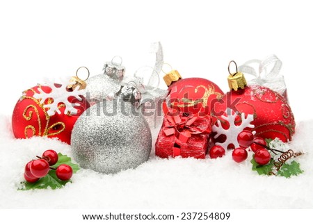 Decoration of red,silver christmas baubles and gifts on snow white background