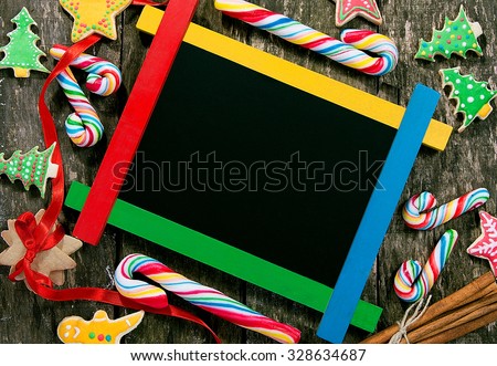 Winter frame:wooden board surrounded by homemade cookies and candy