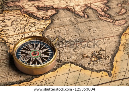 Old compass and rope on vintage map