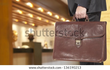Businessman with briefcase in the hotel reception