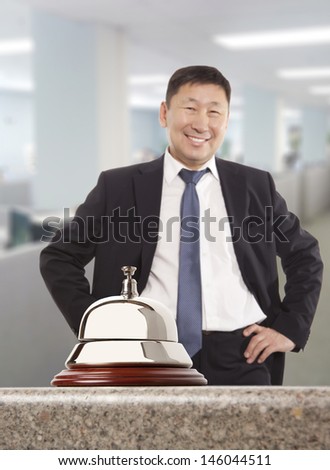 Asian hotel concierge.  Service bell at the hotel
