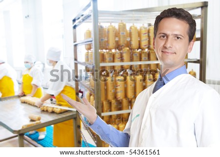 portrait of male seller sausage looking at camera