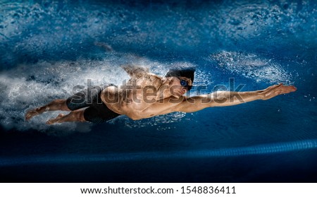 Image, Stock Photo Underwater view of man free diving in blue ocean.