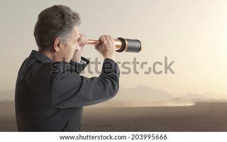 Business concept.  Business man looks through a telescope