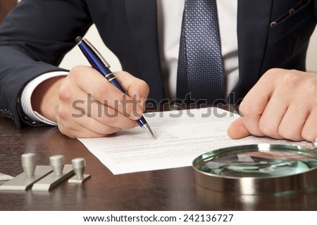 Lawyer, notary signs the documents from our office