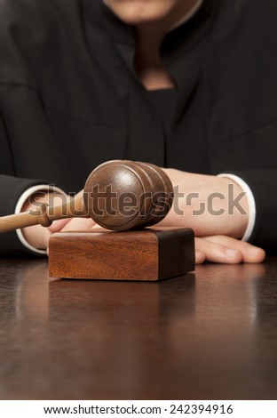 Judge. Referee hammer and a man in judicial robes