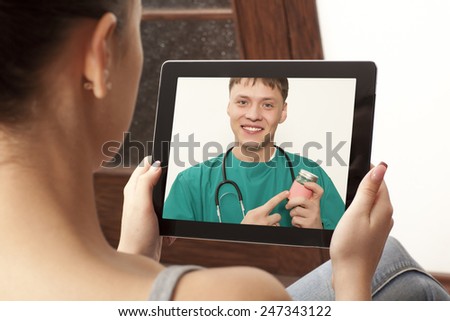Woman having video chat with doctor on laptop at home