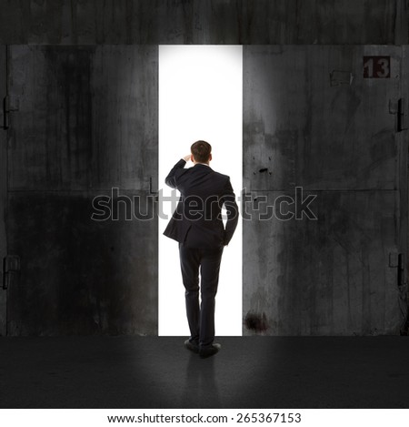 Infinity. Rear view of a businessman standing in front of the exit light