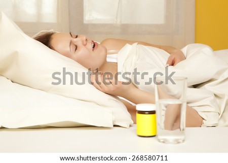 Female in bed at home caught cold, feeling bad, taking medicines, sleeping