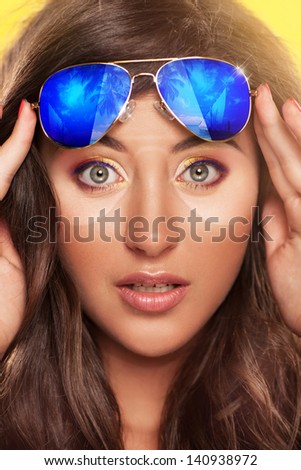 closeup portrait picture of funny young woman in sunglasses, have a tan in form of glasses