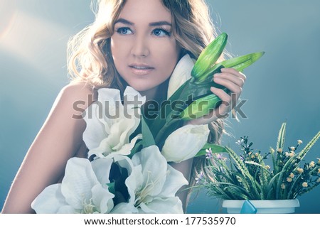 Portrait of Beautiful smiling woman with a lily flowers. Spring, fresh