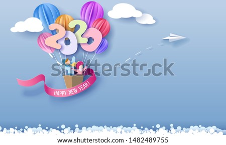 2020 New Year design card with kids in basket of air balloons flying on blue sky background with clouds. Vector paper art illustration. Paper cut and craft style.