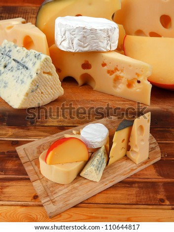 different cheeses served on wooding cutting board