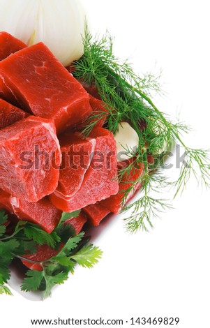 slices of raw fresh beef meat fillet in a white bowls with dill and green peppers isolated over white background