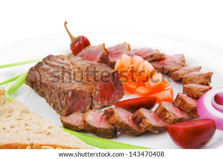 main course : roast red meat slices served on white plate with tomatoes , sprouts and bread  isolated on white background