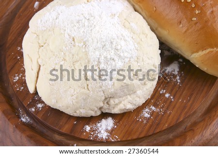 french loaf and white dough on wood top view