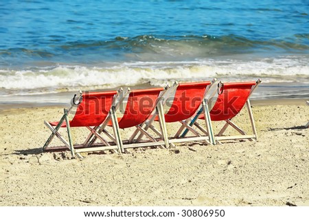 sea beach with chairs on gold sand