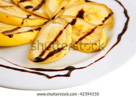 served banana sliced with chocolate sauce on white